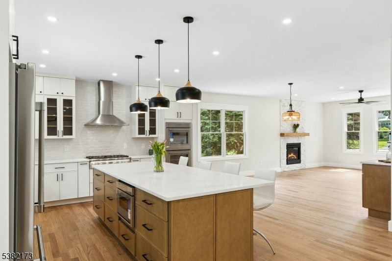 Dining room, Fireplace, Interior, Kitchen, Pendant Lights, Recessed Lighting, Stainless Steel Appliances, Wood Texture Flooring