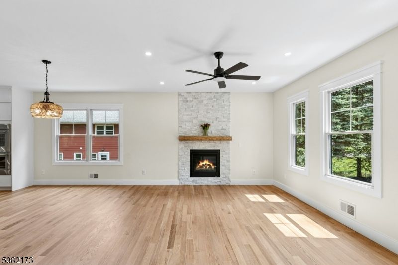 Empty room, Fireplace, Interior, Pendant Lights, Recessed Lighting, Stone Walls, Wood Texture Flooring