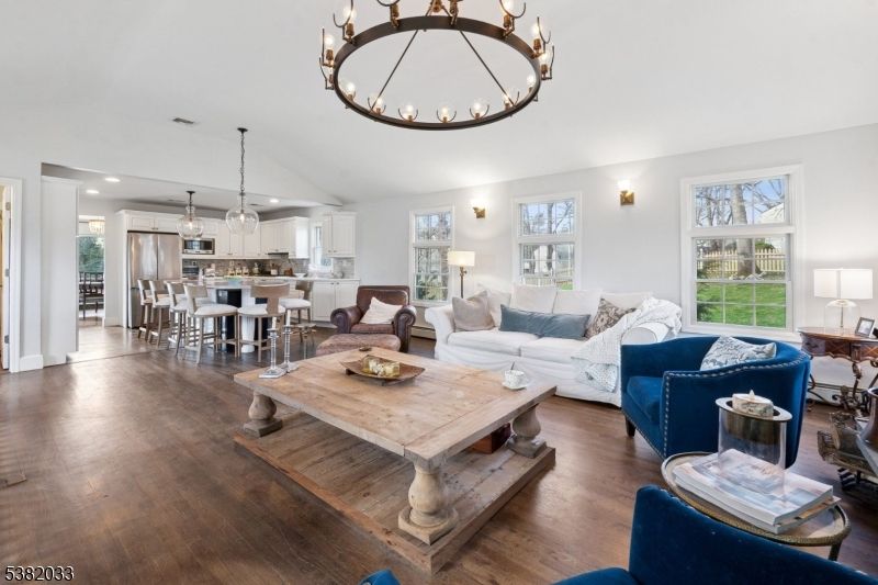 Chandelier, Dining room, Interior, Kitchen, Living room, Pendant Lights, Recessed Lighting, Stainless Steel Appliances, Wood Texture Flooring
