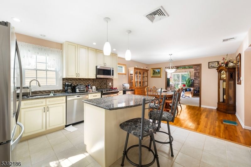 Dining room, Interior, Kitchen, Pendant Lights, Recessed Lighting, Stainless Steel Appliances, Wood Texture Flooring