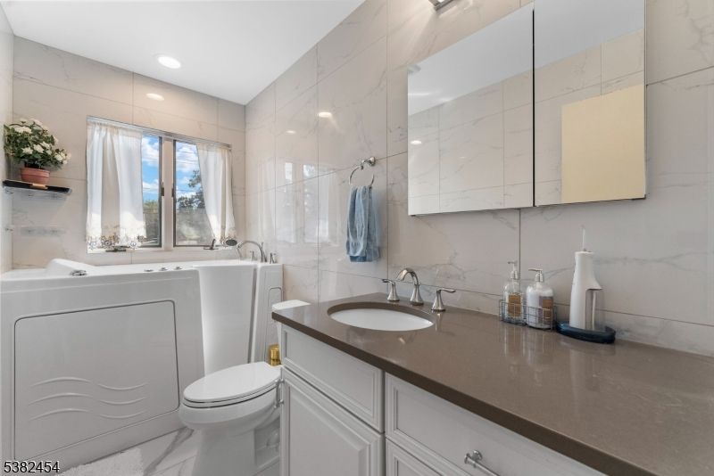 Bathroom, Dual Sink Vanities, Interior, Marble, Marble Walls, Recessed Lighting
