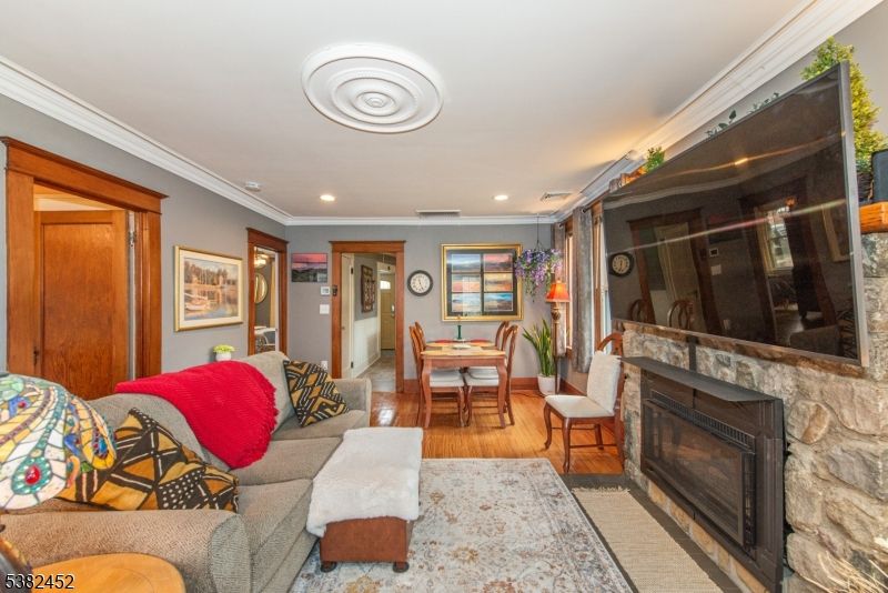 Dining room, Fireplace, Interior, Living room, Recessed Lighting, Wood Texture Flooring