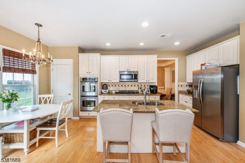 Chandelier, Dining room, Interior, Kitchen, Recessed Lighting, Stainless Steel Appliances, Wood Texture Flooring