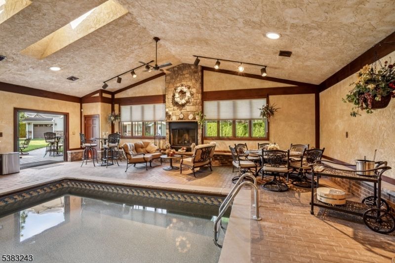 Dining room, Fireplace, Interior, Living room, Pool, Recessed Lighting, Stone Walls