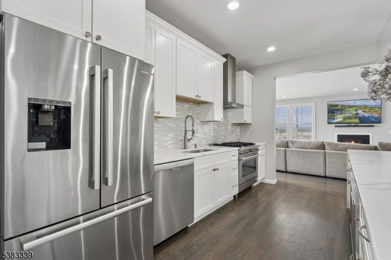Fireplace, Interior, Kitchen, Living room, Recessed Lighting, Stainless Steel Appliances, Wood Texture Flooring