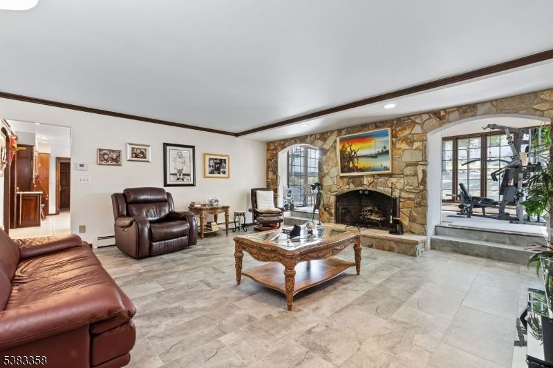 Fireplace, Fitness Equipment, Interior, Living room, Recessed Lighting, Stone Walls