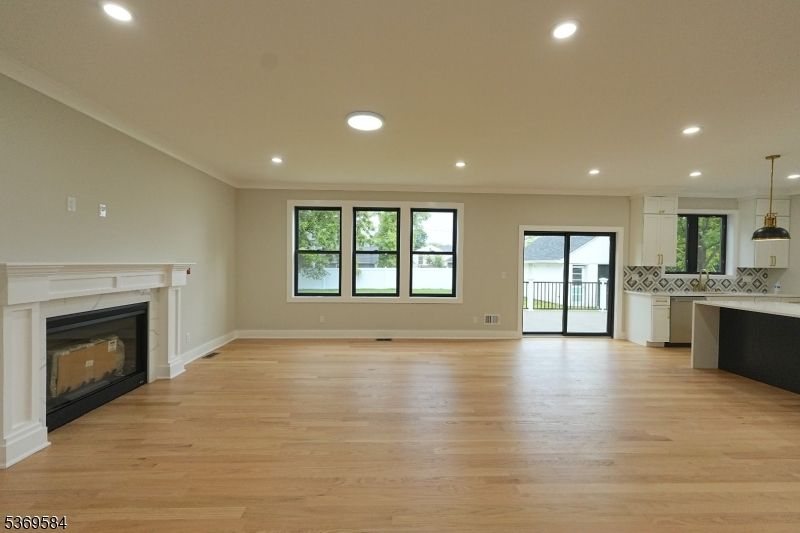 Empty room, Fireplace, Interior, Kitchen, Pendant Lights, Recessed Lighting, Wood Texture Flooring