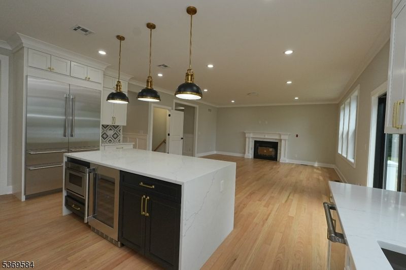 Fireplace, Interior, Kitchen, Pendant Lights, Recessed Lighting, Stainless Steel Appliances, Wood Texture Flooring