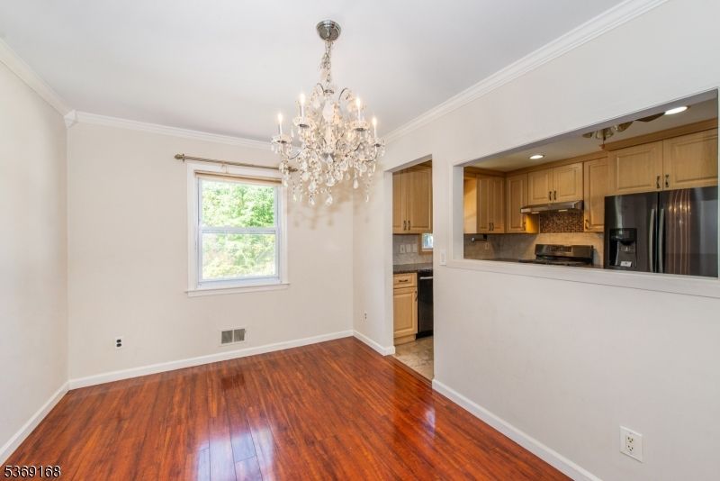Chandelier, Empty room, Interior, Kitchen, Recessed Lighting, Stainless Steel Appliances, Wood Texture Flooring