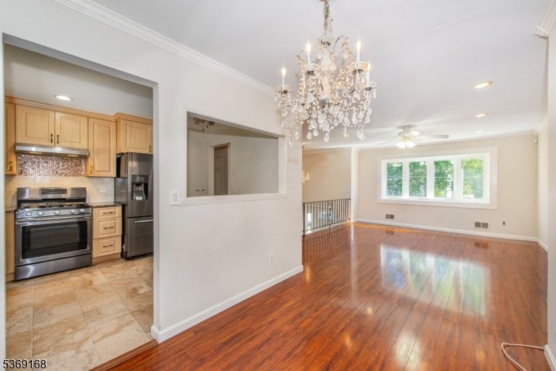Chandelier, Empty room, Interior, Kitchen, Recessed Lighting, Stainless Steel Appliances, Wood Texture Flooring