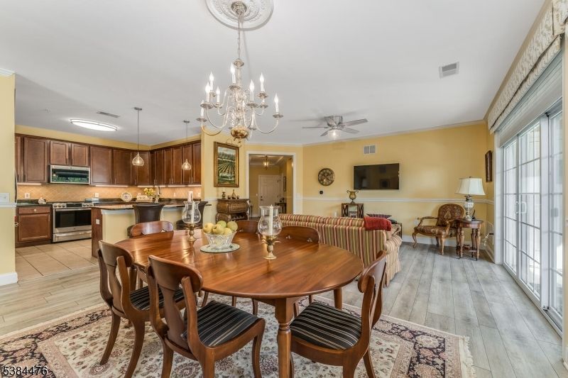 Chandelier, Dining room, Interior, Kitchen, Living room, Pendant Lights, Stainless Steel Appliances, Wood Texture Flooring