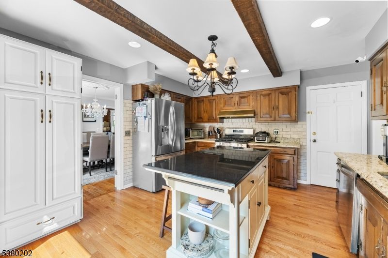 Chandelier, Dining room, Interior, Kitchen, Recessed Lighting, Stainless Steel Appliances, Wooden Beams, Wood Texture Flooring