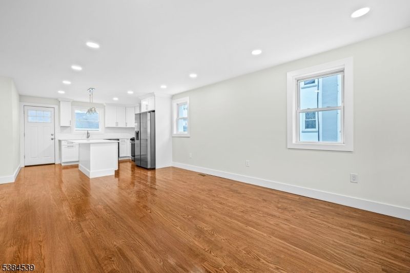 Empty room, Interior, Kitchen, Pendant Lights, Recessed Lighting, Stainless Steel Appliances, Wood Texture Flooring