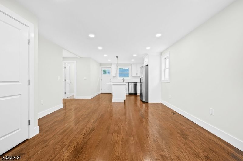 Empty room, Interior, Kitchen, Pendant Lights, Recessed Lighting, Stainless Steel Appliances, Wood Texture Flooring