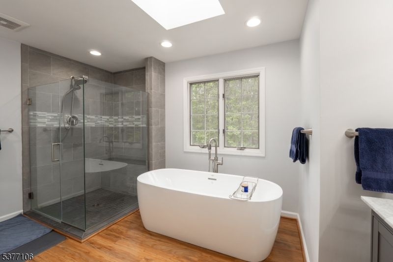 Bathroom, Free Standing Baths, Glass Shower, Interior, Recessed Lighting, Wood Texture Flooring