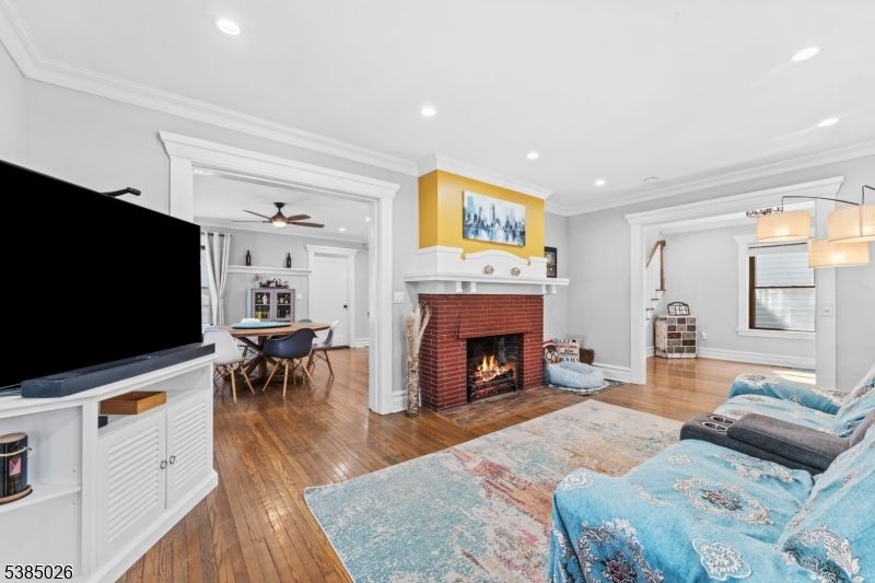Dining room, Fireplace, Interior, Living room, Recessed Lighting, Wood Texture Flooring