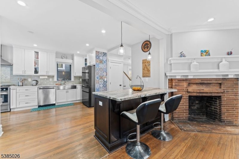 Fireplace, Interior, Kitchen, Pendant Lights, Recessed Lighting, Stainless Steel Appliances, Stone Walls, Wood Texture Flooring