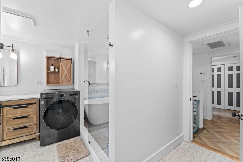 Bathroom, Dual Sink Vanities, Free Standing Baths, Interior, Recessed Lighting, Washer, Wood Texture Flooring