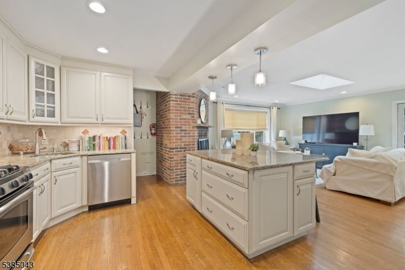 Fireplace, Interior, Kitchen, Living room, Pendant Lights, Recessed Lighting, Stainless Steel Appliances, Stone Walls, Wood Texture Flooring