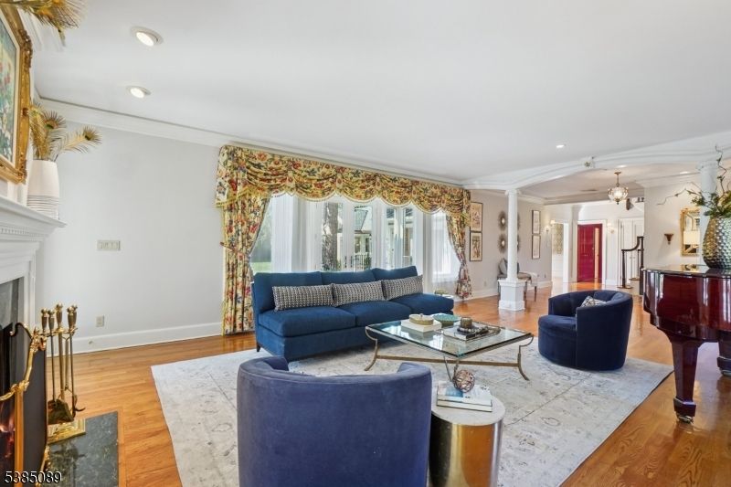 Chandelier, Fireplace, Interior, Living room, Piano, Recessed Lighting, Wood Texture Flooring