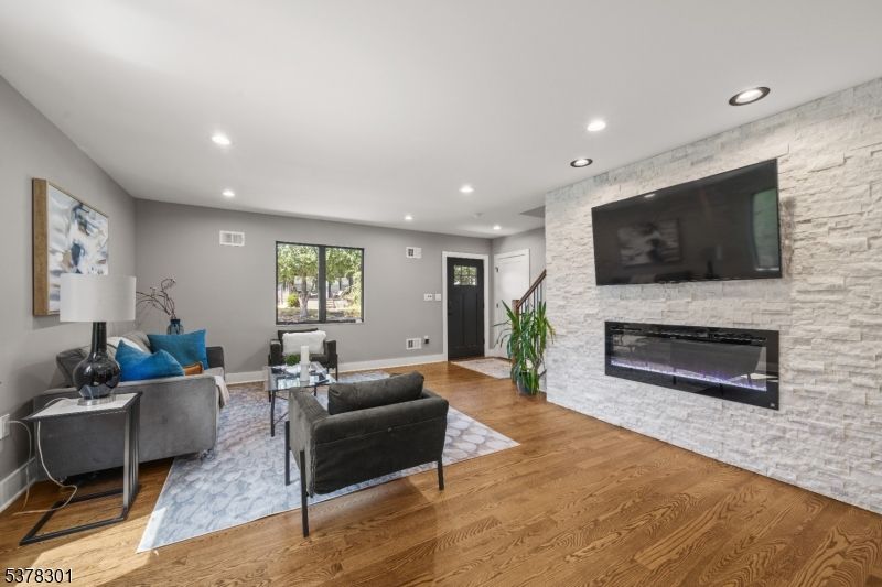 Fireplace, Interior, Living room, Recessed Lighting, Stone Walls, Wood Texture Flooring