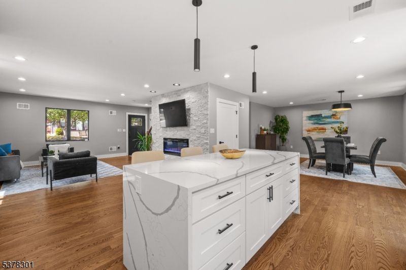 Dining room, Fireplace, Interior, Kitchen, Living room, Pendant Lights, Recessed Lighting, Stone Walls, Wood Texture Flooring