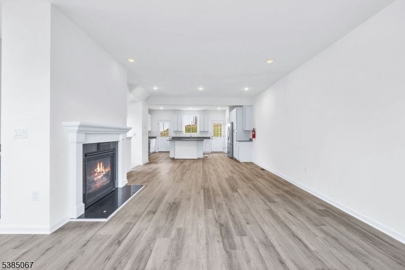 Empty room, Fireplace, Interior, Kitchen, Recessed Lighting, Wood Texture Flooring