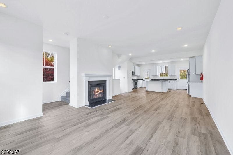 Empty room, Fireplace, Interior, Kitchen, Recessed Lighting, Wood Texture Flooring