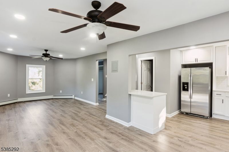 Empty room, Interior, Kitchen, Recessed Lighting, Stainless Steel Appliances, Wood Texture Flooring