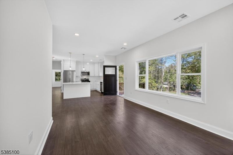 Empty room, Interior, Kitchen, Pendant Lights, Recessed Lighting, Stainless Steel Appliances, Wood Texture Flooring