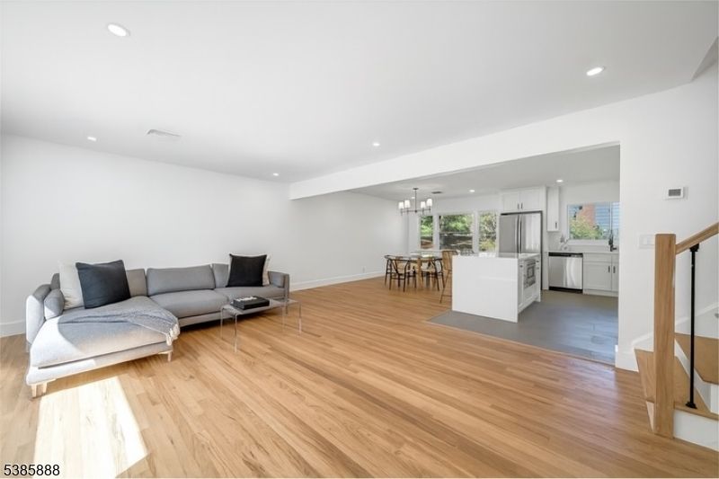 Chandelier, Dining room, Interior, Kitchen, Living room, Pendant Lights, Recessed Lighting, Stainless Steel Appliances, Wood Texture Flooring