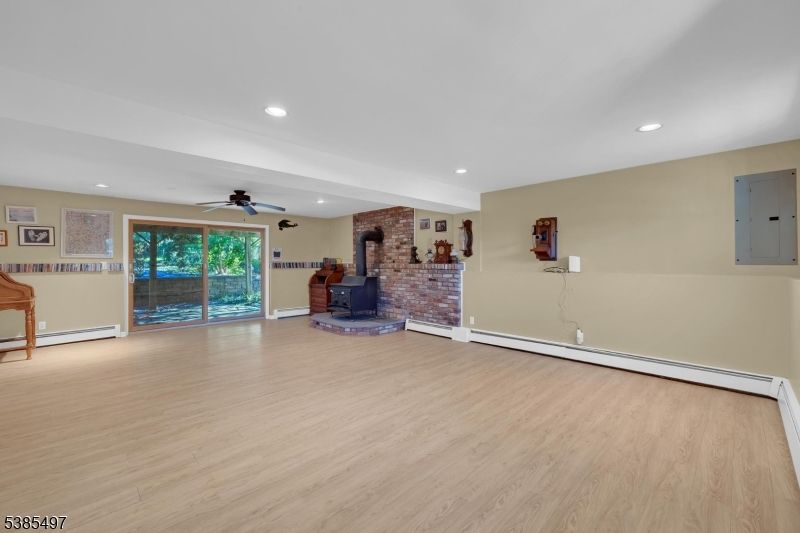 Empty room, Fireplace, Interior, Recessed Lighting, Stone Walls, Wood Texture Flooring