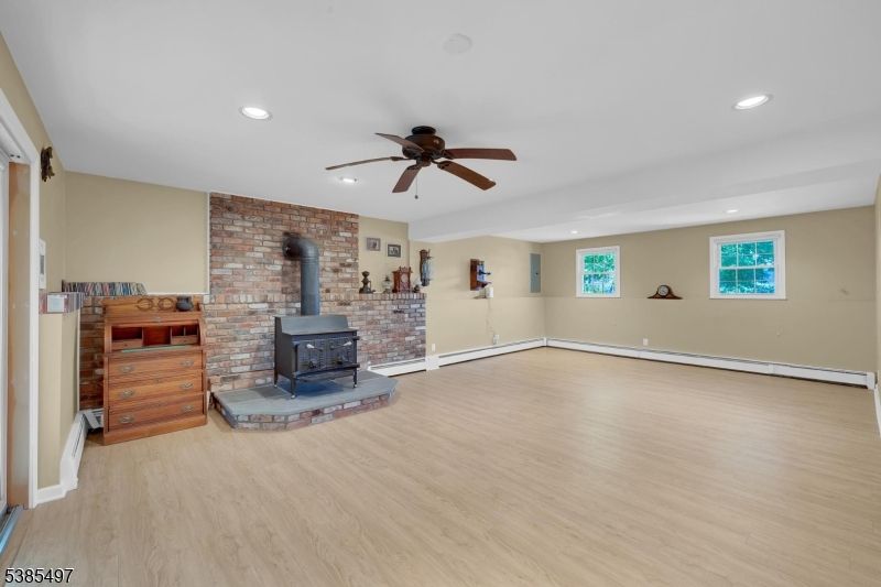Empty room, Fireplace, Interior, Recessed Lighting, Stone Walls, Wood Texture Flooring