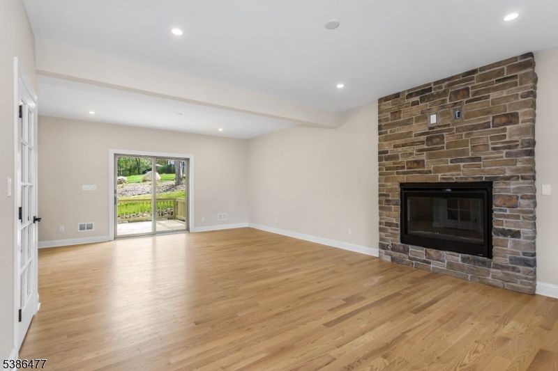 Empty room, Fireplace, Interior, Recessed Lighting, Stone Walls, Wood Texture Flooring
