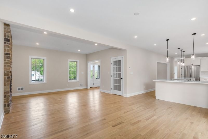 Empty room, Interior, Kitchen, Pendant Lights, Recessed Lighting, Stainless Steel Appliances, Wood Texture Flooring