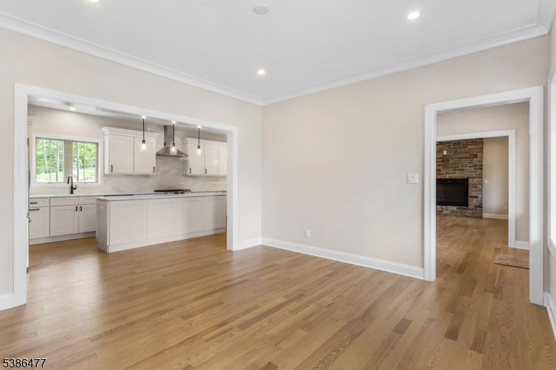 Empty room, Fireplace, Interior, Kitchen, Pendant Lights, Recessed Lighting, Stone Walls, Wood Texture Flooring