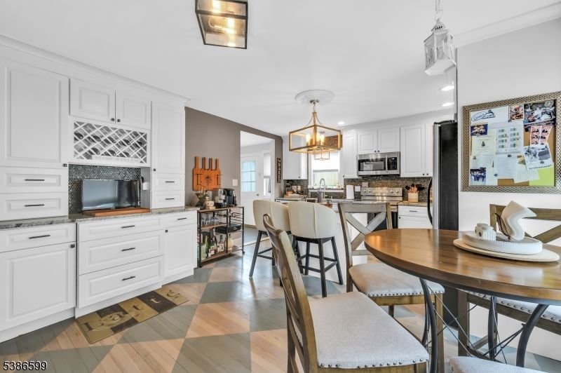 Dining room, Interior, Kitchen, Pendant Lights, Recessed Lighting, Stainless Steel Appliances, Wood Texture Flooring