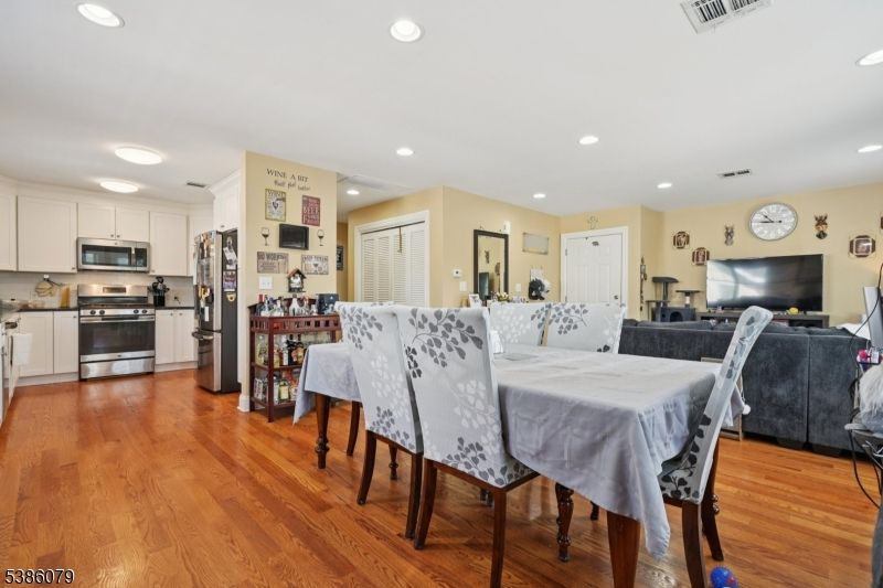 Dining room, Interior, Kitchen, Living room, Recessed Lighting, Stainless Steel Appliances, Wood Texture Flooring