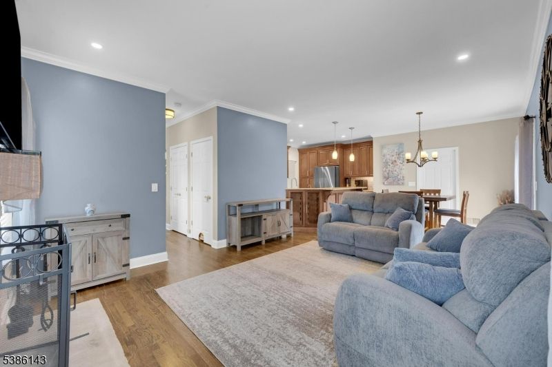 Chandelier, Dining room, Interior, Kitchen, Living room, Pendant Lights, Recessed Lighting, Stainless Steel Appliances, Wood Texture Flooring