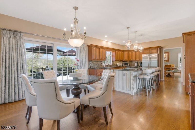 Chandelier, Dining room, Interior, Kitchen, Pendant Lights, Recessed Lighting, Stainless Steel Appliances, Wood Texture Flooring