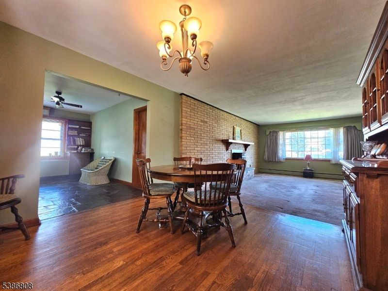 Chandelier, Dining room, Fireplace, Interior, Stone Walls, Wood Texture Flooring