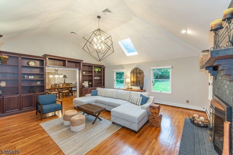 Chandelier, Dining room, Fireplace, Interior, Living room, Pendant Lights, Recessed Lighting, Wood Texture Flooring