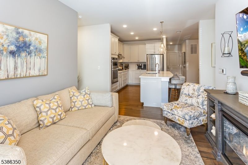 Fireplace, Interior, Kitchen, Living room, Pendant Lights, Recessed Lighting, Stainless Steel Appliances, Wood Texture Flooring