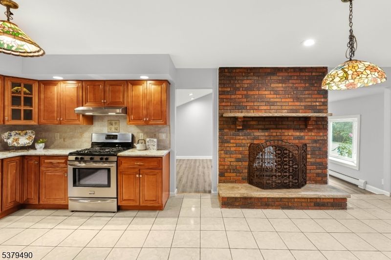 Fireplace, Interior, Kitchen, Pendant Lights, Recessed Lighting, Stainless Steel Appliances, Stone Walls