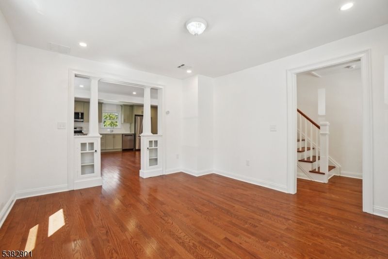 Empty room, Interior, Kitchen, Recessed Lighting, Stainless Steel Appliances, Wood Texture Flooring