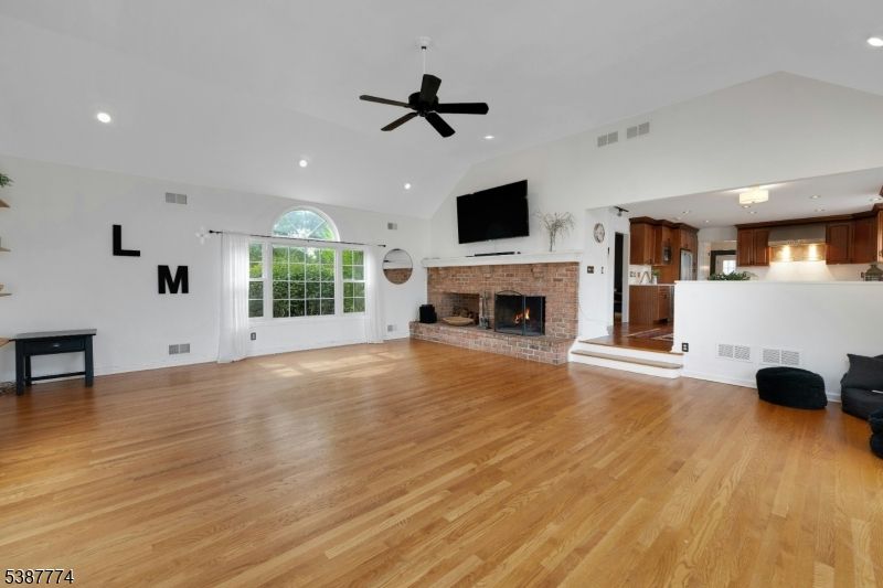 Chandelier, Empty room, Fireplace, Interior, Kitchen, Recessed Lighting, Wood Texture Flooring