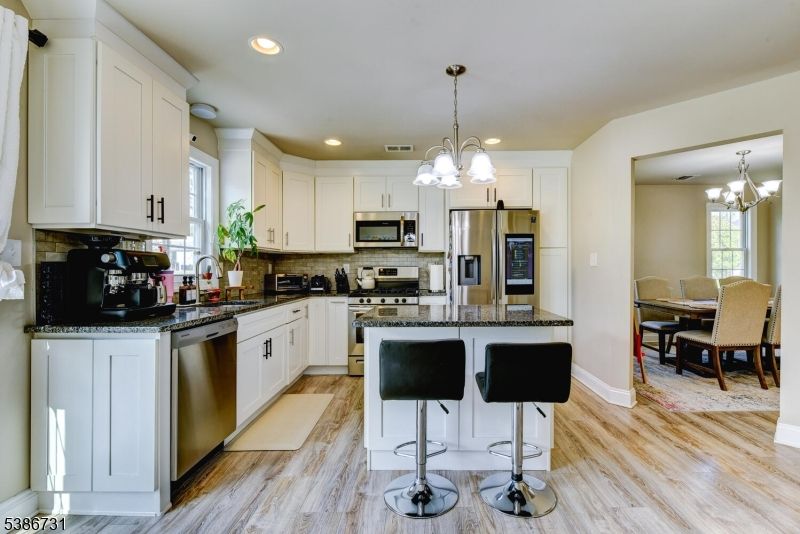 Chandelier, Dining room, Interior, Kitchen, Pendant Lights, Recessed Lighting, Stainless Steel Appliances, Wood Texture Flooring
