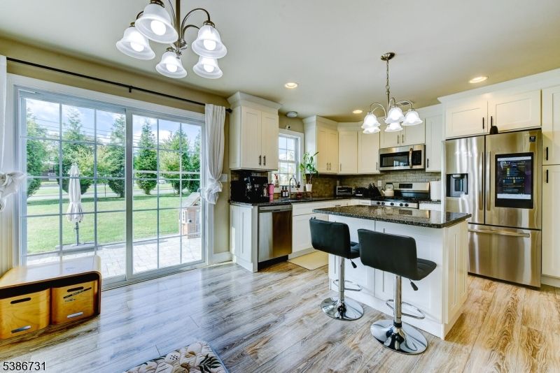 Chandelier, Interior, Kitchen, Pendant Lights, Recessed Lighting, Stainless Steel Appliances, Wood Texture Flooring
