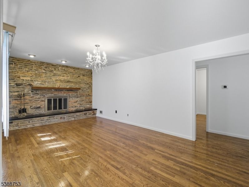 Chandelier, Empty room, Fireplace, Interior, Stone Walls, Wood Texture Flooring