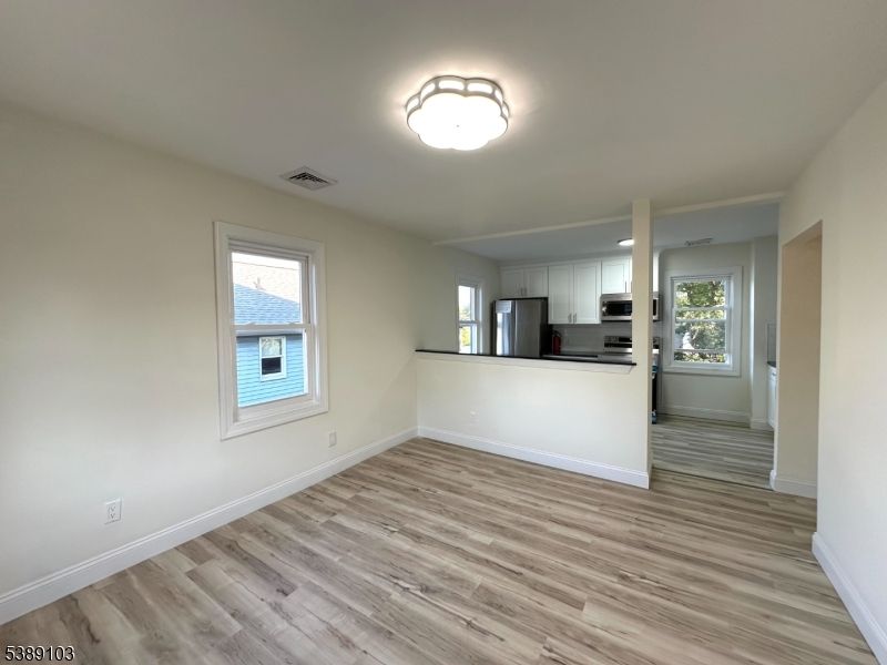 Empty room, Interior, Kitchen, Stainless Steel Appliances, Wood Texture Flooring